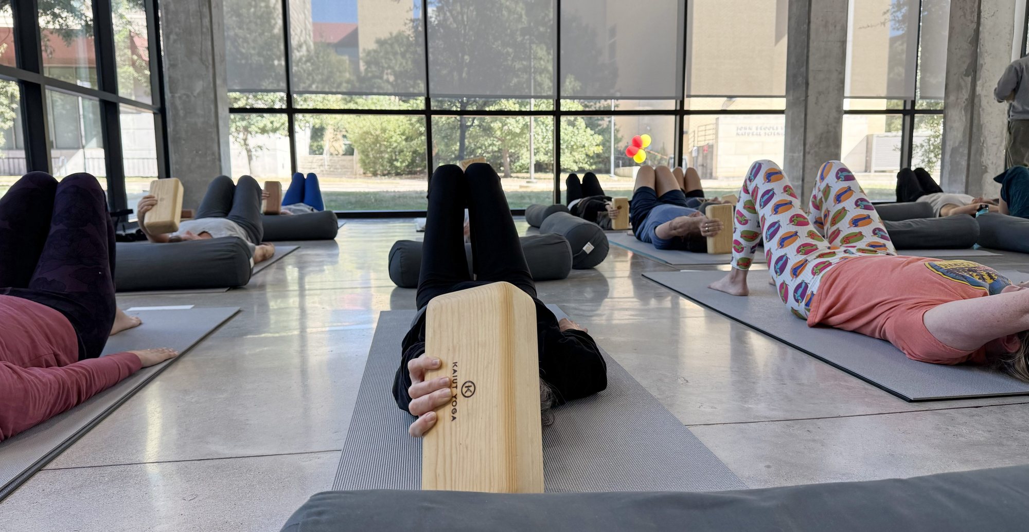 Students on mats across the studio floor during a class